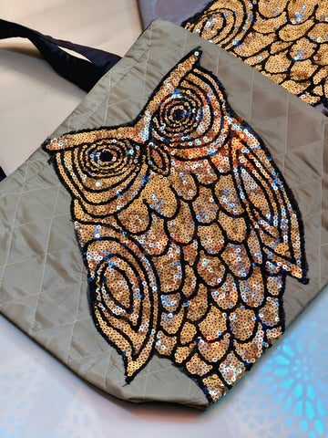Sequined owl design on a textured surface