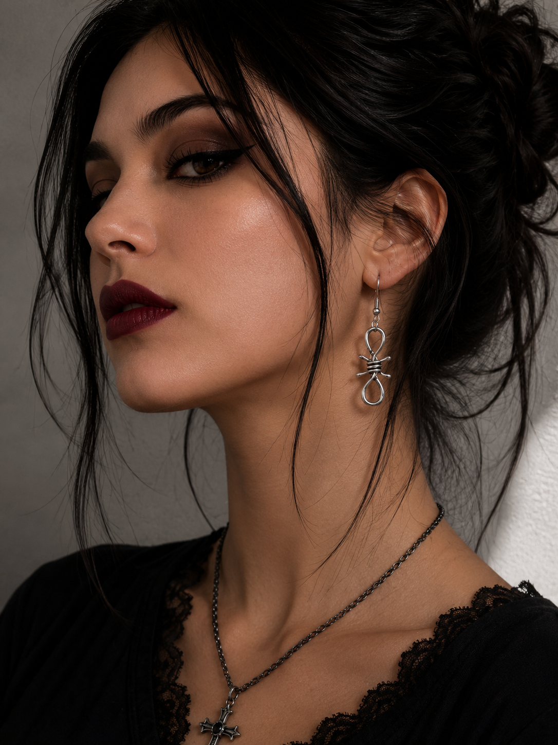 Midnight Grunge 5-Pair Silver Gothic Earring Set on a marble tray, featuring textured snake hoops, sword dangles, skull butterflies, spiders, and witch knot earrings by Marjan Collections
