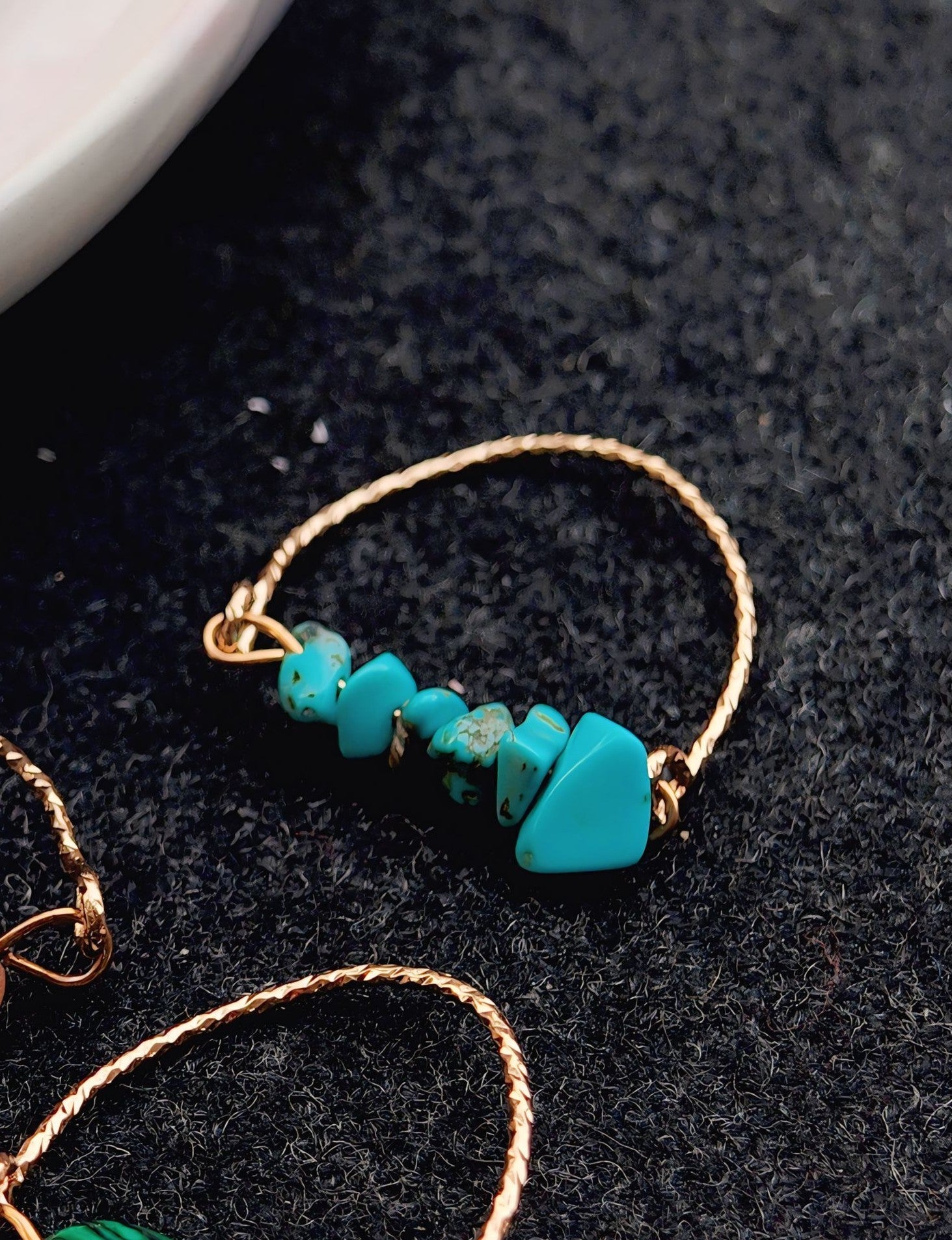Turquoise beaded bracelet on a dark surface