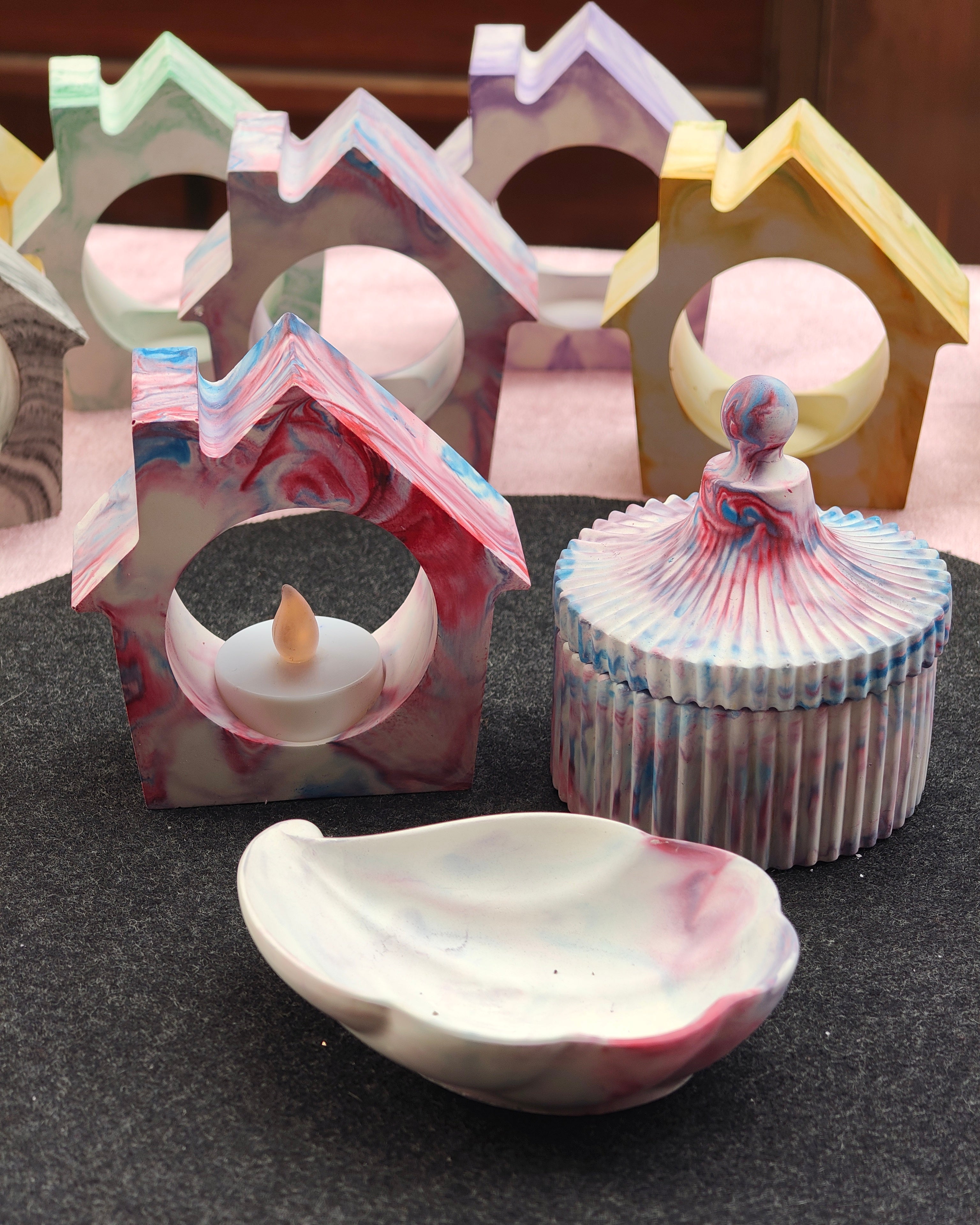 Set of ceramic or porcelain items with marbled design on a dark surface